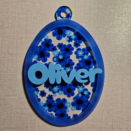 Egg ornament made with blue floral acrylic, semi-translucent blue acrylic, and pastel blue acrylic