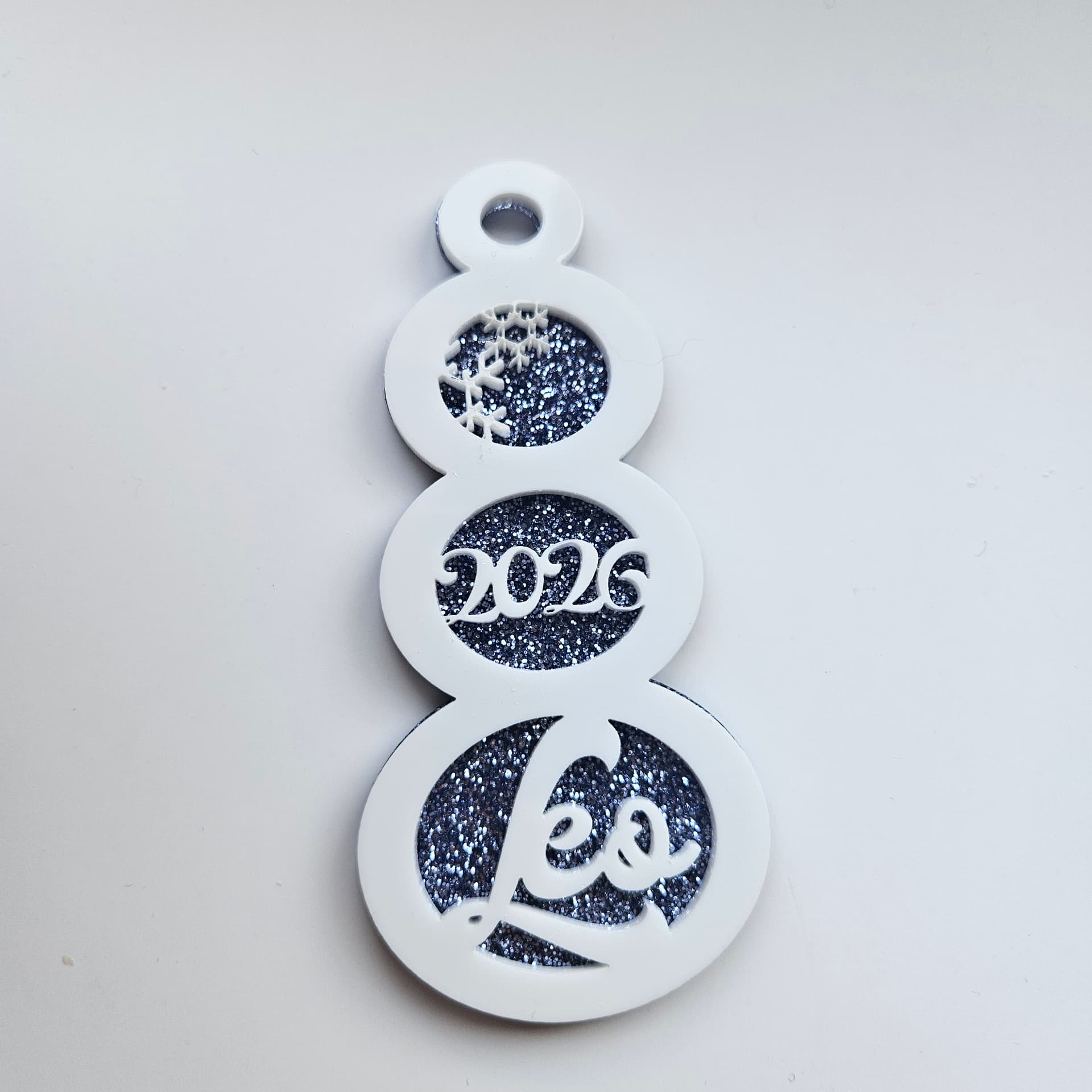 Blue glitter snowman ornament with white pastel finish