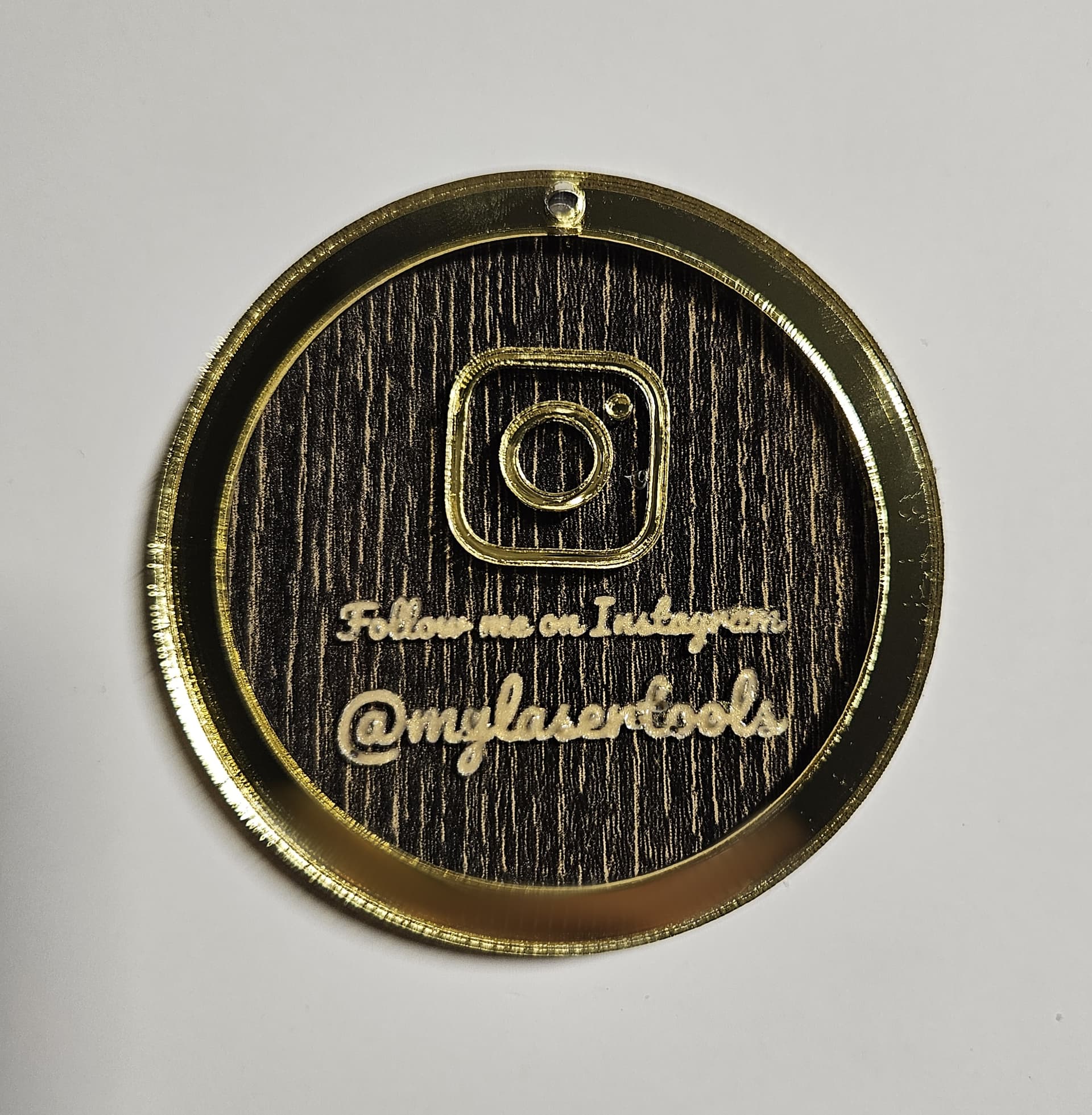 Multi-layer Instagram keychain made from black wood acrylic and gold mirror acrylic.