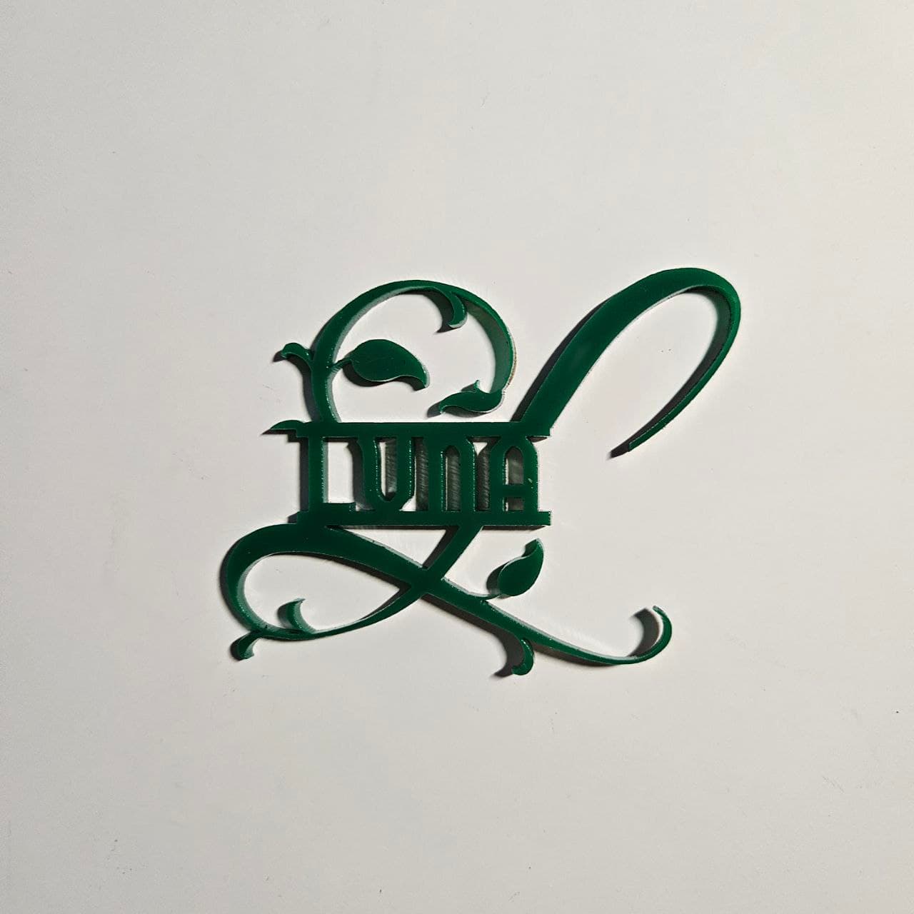 Split monogram made with green dual finish cast acrylic