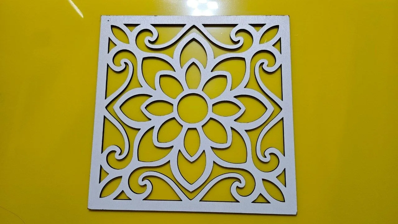 Single white plywood floral panel laid on a yellow acrylic background