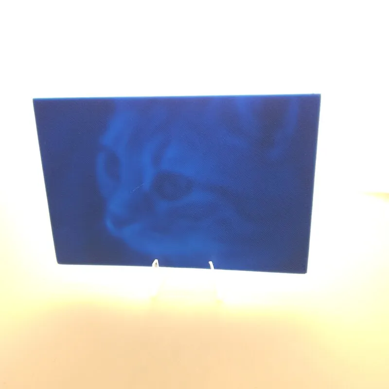 Backlit lithophane 3D-printed in blue PLA, image revealed when lit from behind