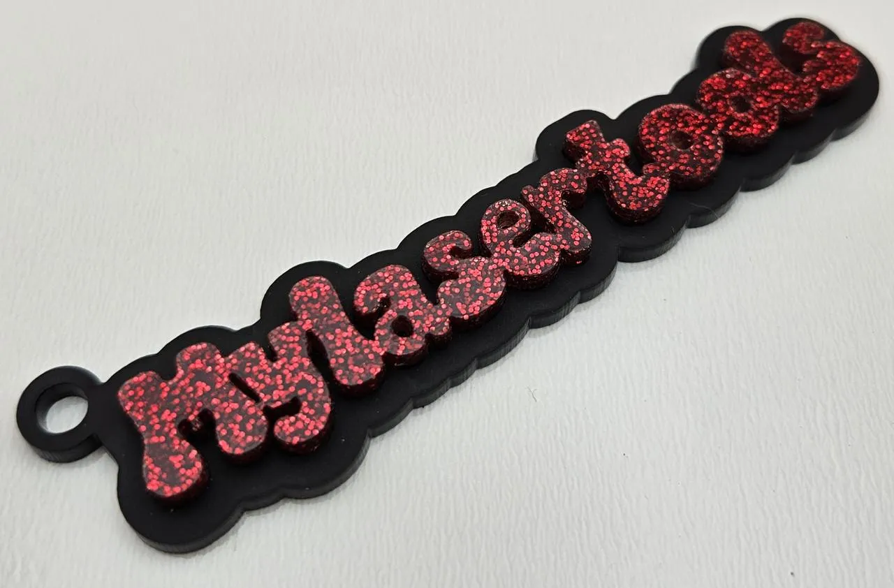 Two-layer keychain with the text mylasertools.com