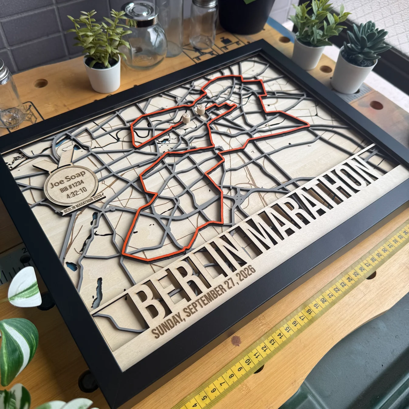 Layered wooden Berlin Marathon route map by The Magic Crayons, with the course picked out in orange and a personalised finisher medallion, made with the MyLaserTools map generator.