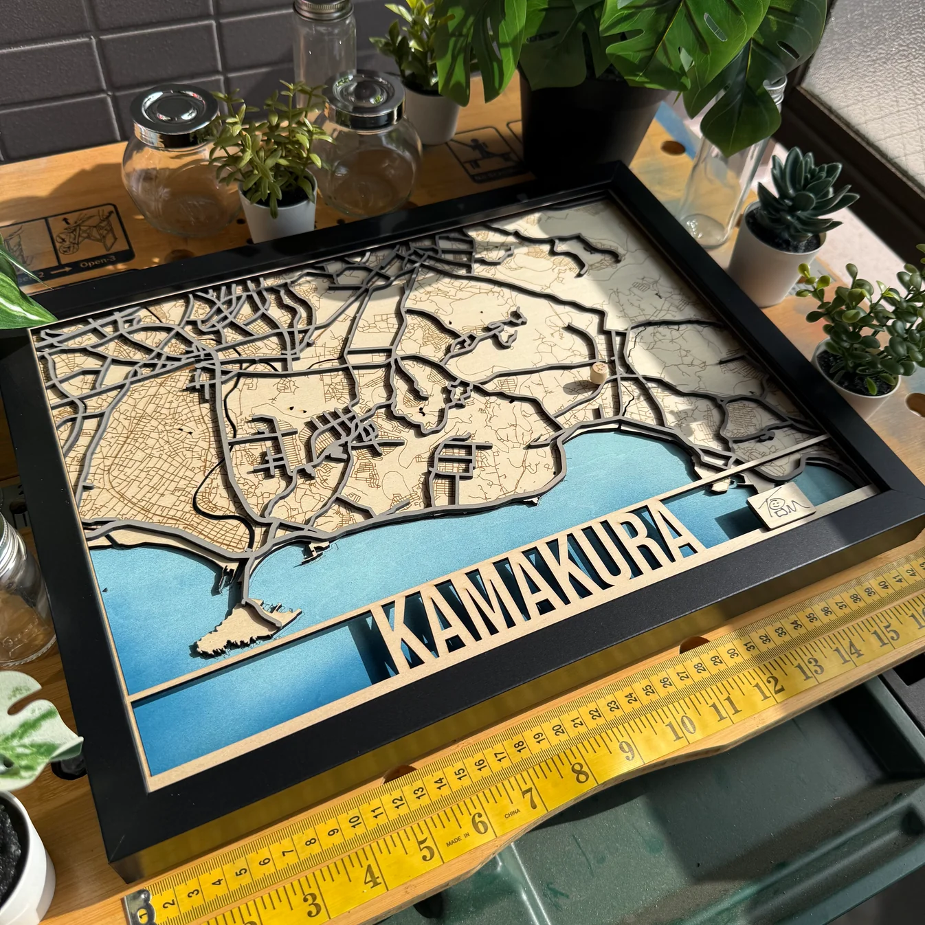 Multi-layer wooden Kamakura and Enoshima coastal map with blue water layers and cut-out lettering, made by The Magic Crayons with the MyLaserTools map generator.