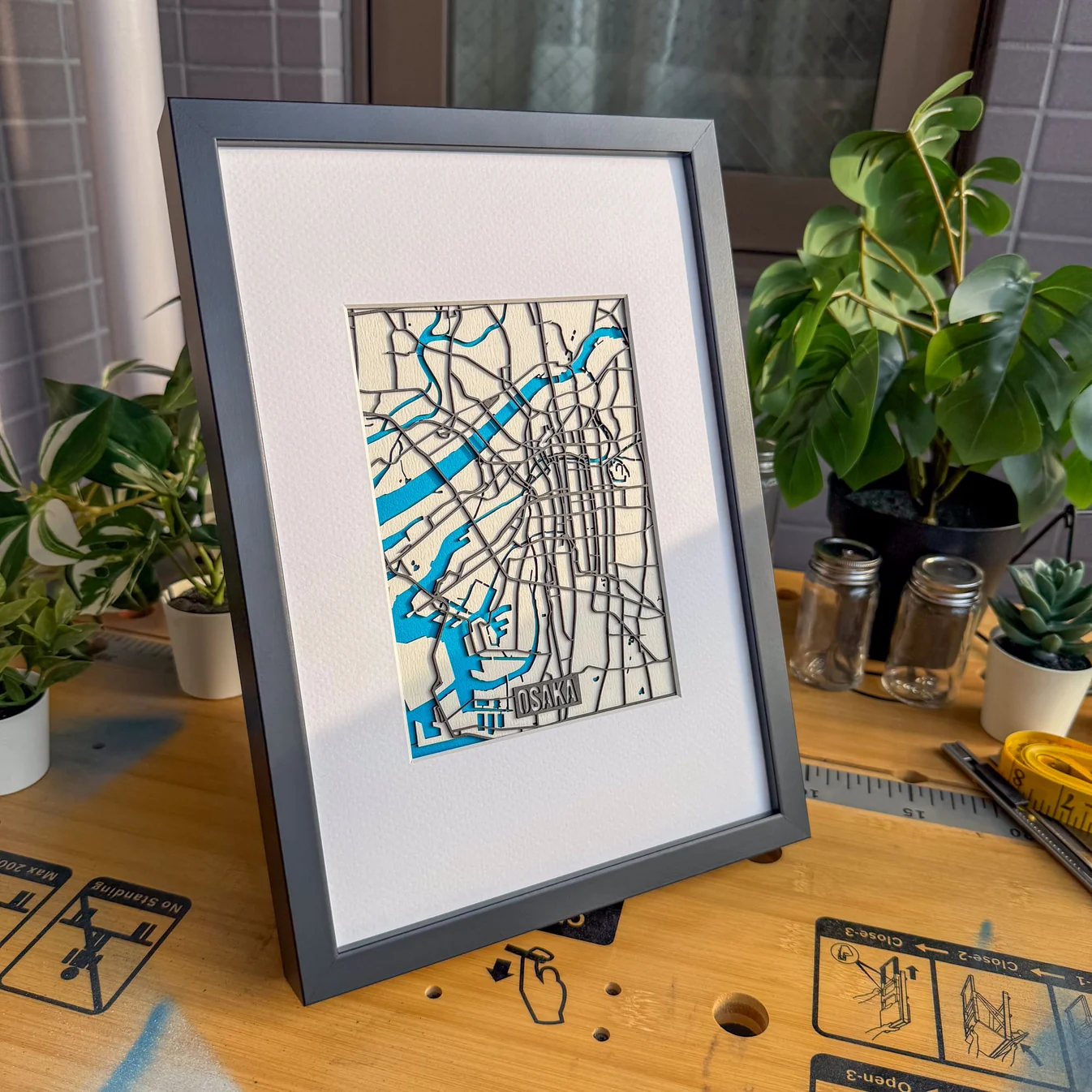 Framed A4 laser-cut Osaka city map in white and blue by The Magic Crayons, made with the MyLaserTools map generator.