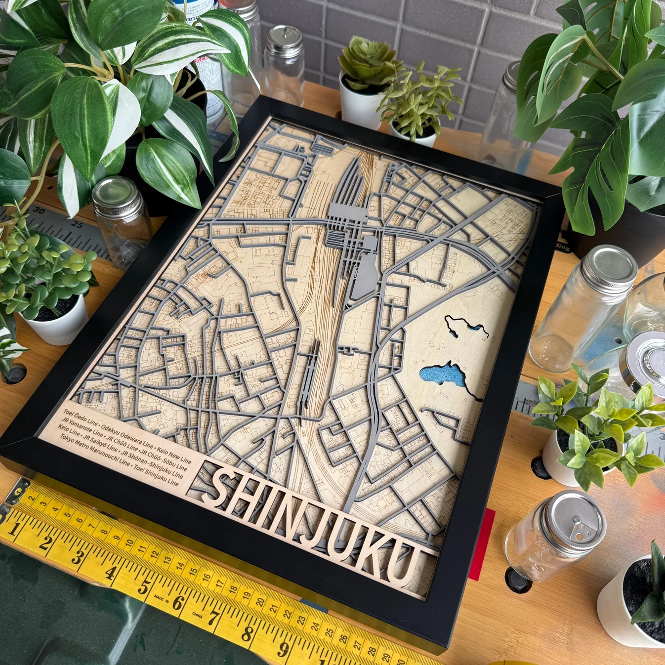 Detailed layered wooden Shinjuku station railway map with engraved rail line names and cut-out lettering, made by The Magic Crayons with the MyLaserTools map generator.