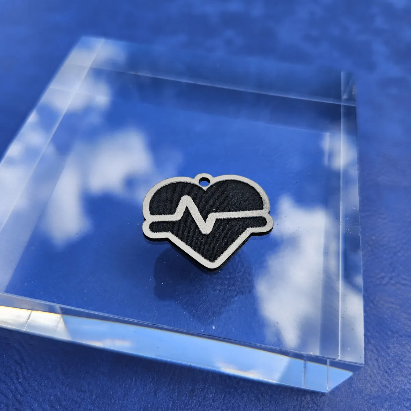 Black and white layered broken-heart keychain charm by Sofia Reyker, made with MyLaserTools.